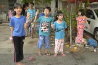 Children flash the three-fingered symbol of resistance as they join an anti-coup protest in Yangon, Myanmar, Saturday, April 10, 2021. Security forces in Myanmar cracked down heavily again on anti-coup protesters Friday even as the military downplayed reports of state violence.(AP Photo)