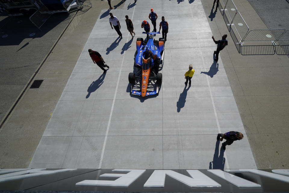 The car of Scott Dixon, of New Zealand, is pushed to pit lane for qualifications for the Indianapolis 500 auto race at Indianapolis Motor Speedway, Saturday, Aug. 15, 2020, in Indianapolis. (AP Photo/Darron Cummings)