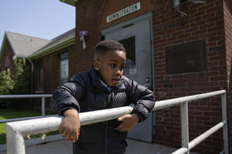 Davi Stewart Roberts, 4-year-old, waits to go through security with his mother Jada Lesure, 23, to visit his grandmother Erika Ray at Logan Correctional Center, Saturday, May 20, 2023, in Lincoln, Illinois. Rare programs like the Reunification Ride, a donation-dependent initiative that buses prisoners' family members from Chicago to Illinois' largest women's prison every month so they can spend time with their mothers and grandmothers, are a crucial lifeline for families, prisoners say. (AP Photo/Erin Hooley)