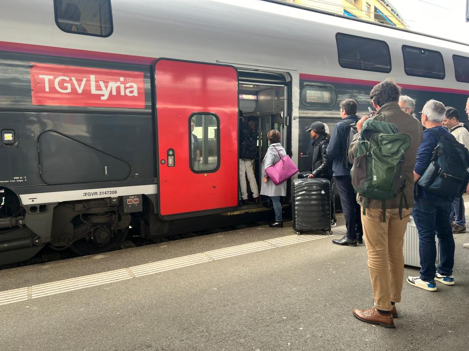 Passengers lining up to board the TGV Lyria at Geneva train station