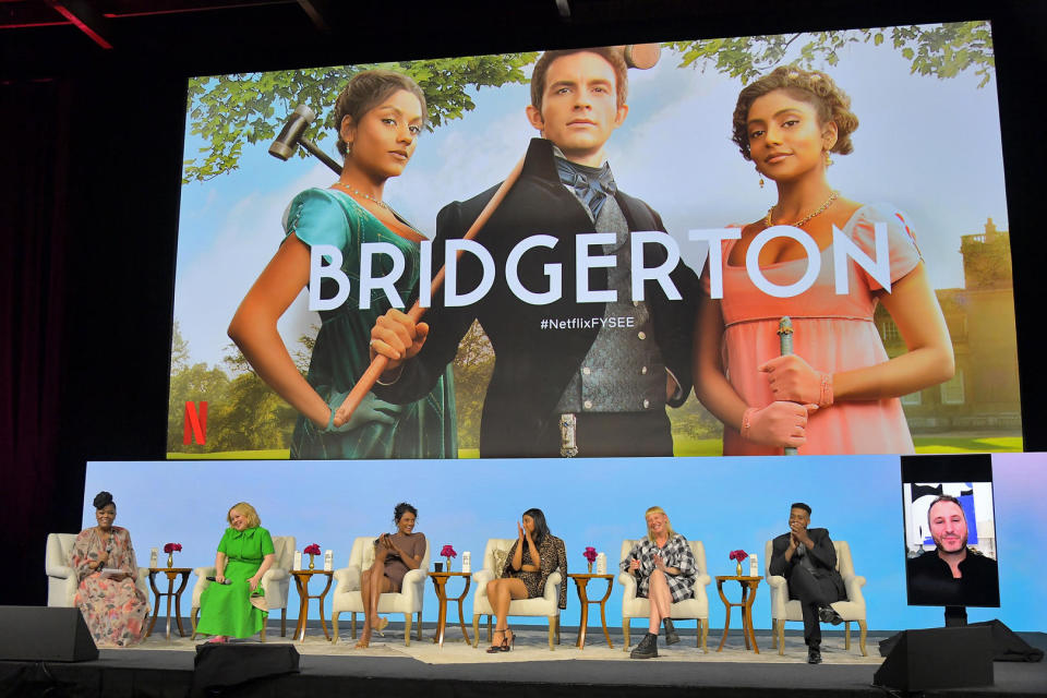 (L-R) Yvette Nicole Brown, Nicola Coughlan, Simone Ashely, Charithra Chandran, Sophie Canale, Kris Bowers and Chris Van Dusen (video screen) - Credit: Netflix