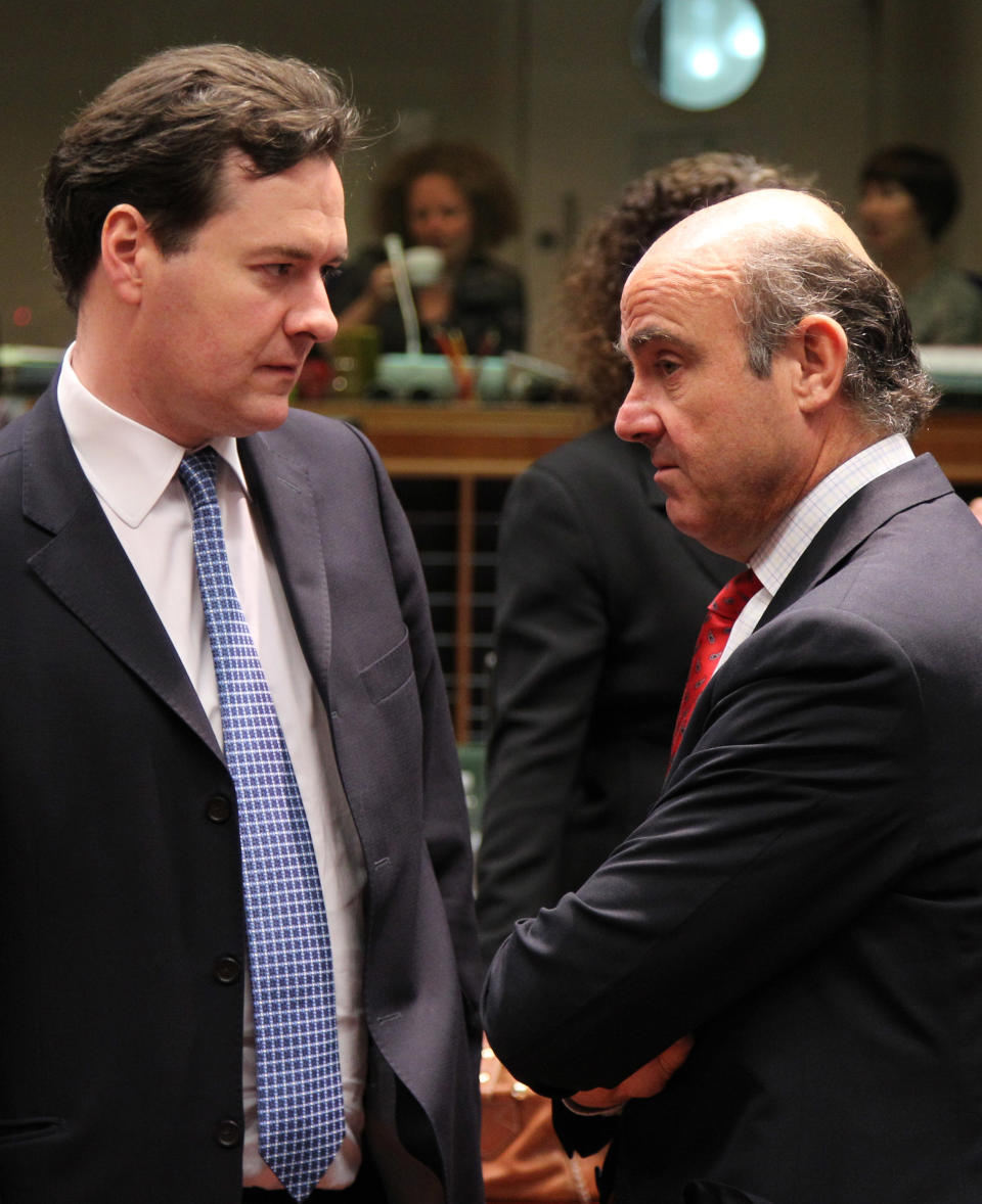 British Chancellor of the Exchequer George Osborne, left, talks with Spanish Finance Minister Luis de Guindos Jurado, during the EU Finance ministerial meeting at the European Council building in Brussels, Tuesday, May 15, 2012. (AP Photo/Yves Logghe)