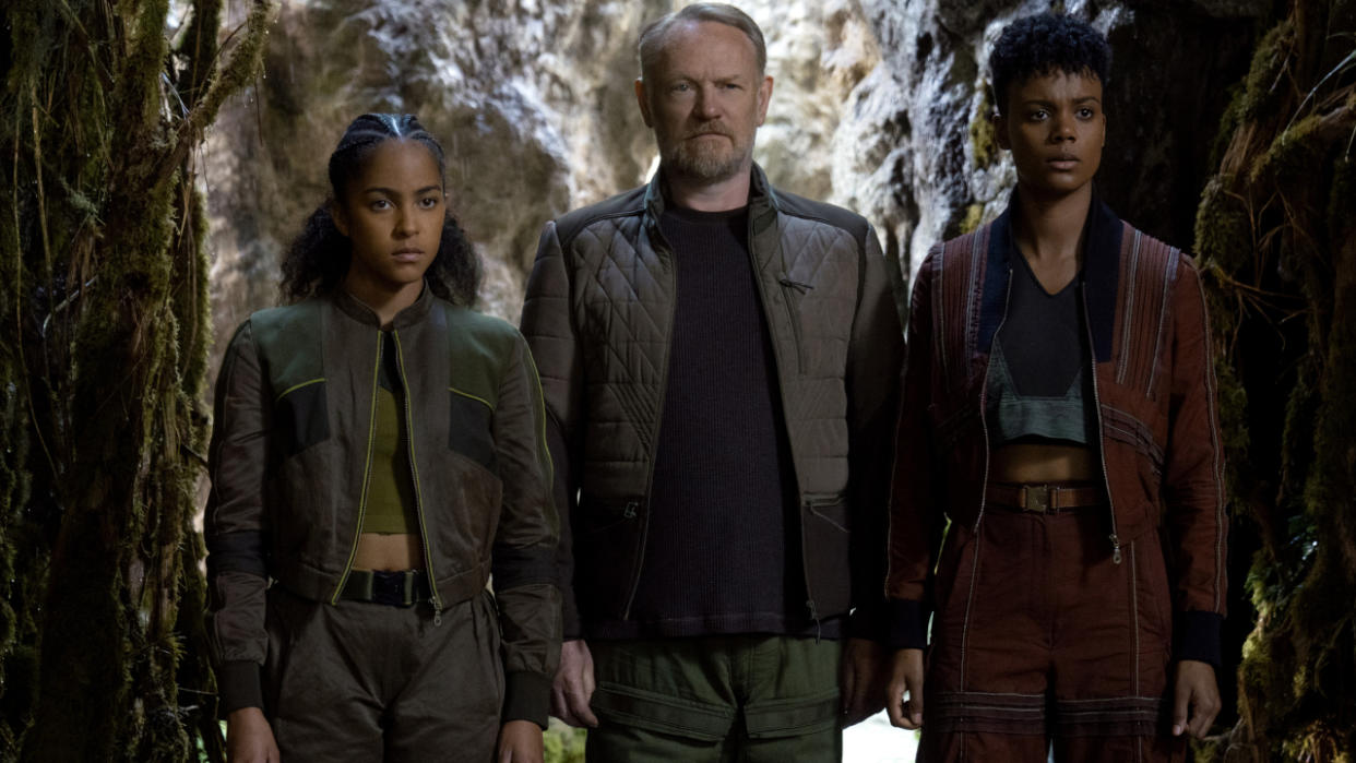  Lou Llobell, Jared Harris, and Leah Harvey gathered together in a forest scene in Foundation Season 2. 