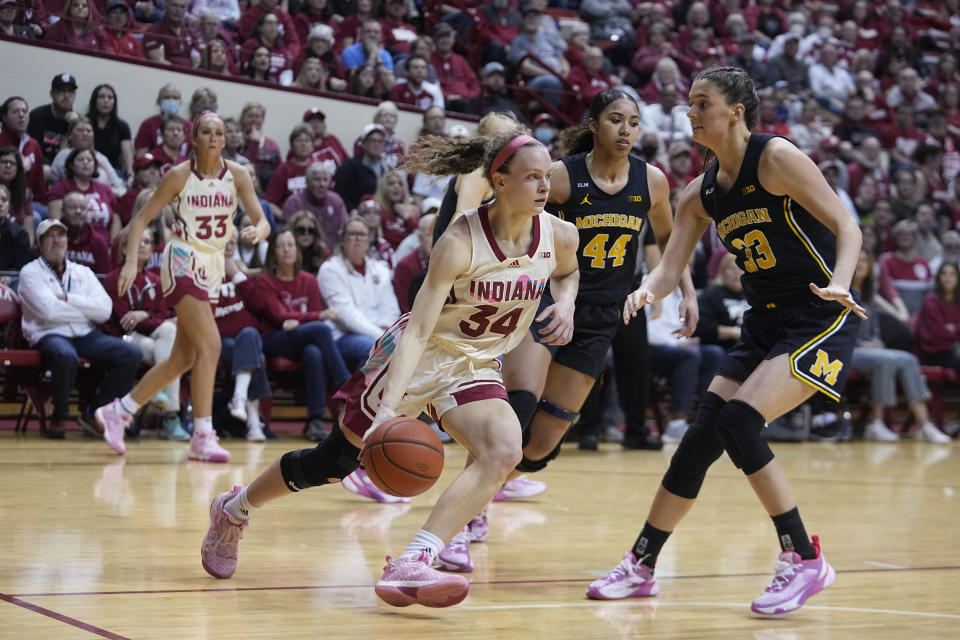Indiana's Grace Berger (34) goes to the basket against Michigan's Emily Kiser (33) during the second half of an NCAA college basketball game Thursday, Feb. 16, 2023, in Bloomington, Ind. (AP Photo/Darron Cummings)