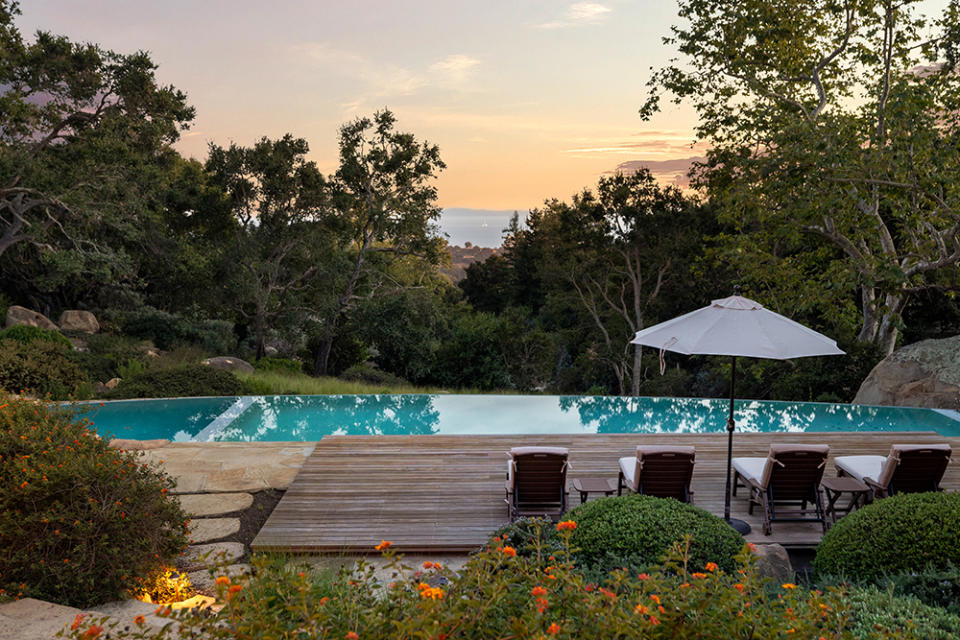 A sail-shaped pool overlooks the ocean.