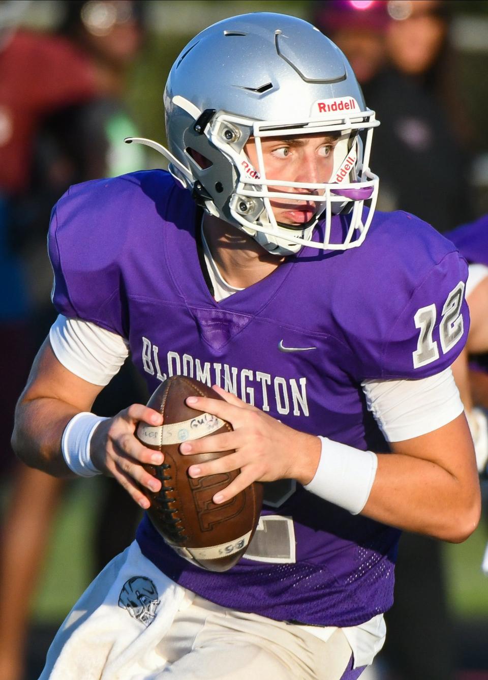 Bloomington South’s Jarrin Alley (12) rolls out to pass during the scrimmage against Lawrence Central at South on Friday, August 11, 2023.