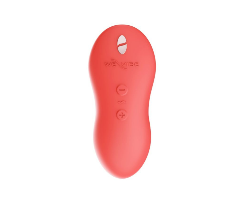 A coral small silicone vibrating massage toy against a white background.