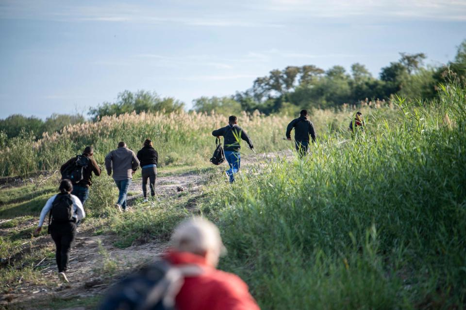 A group of migrants look for a place to cross the Rio Grande in Piedras Negras, Mexico on November, 16, 2022