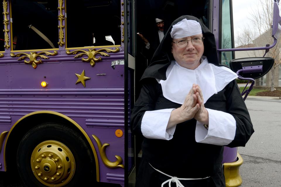 The Asheville Citizen-Times beer guy Tony Kiss poses in front of a LaZoom Comedy Tours bus during the celebration of the release of the limited edition Sister Bad Habit Amber Ale Tuesday, April 7, 2015.