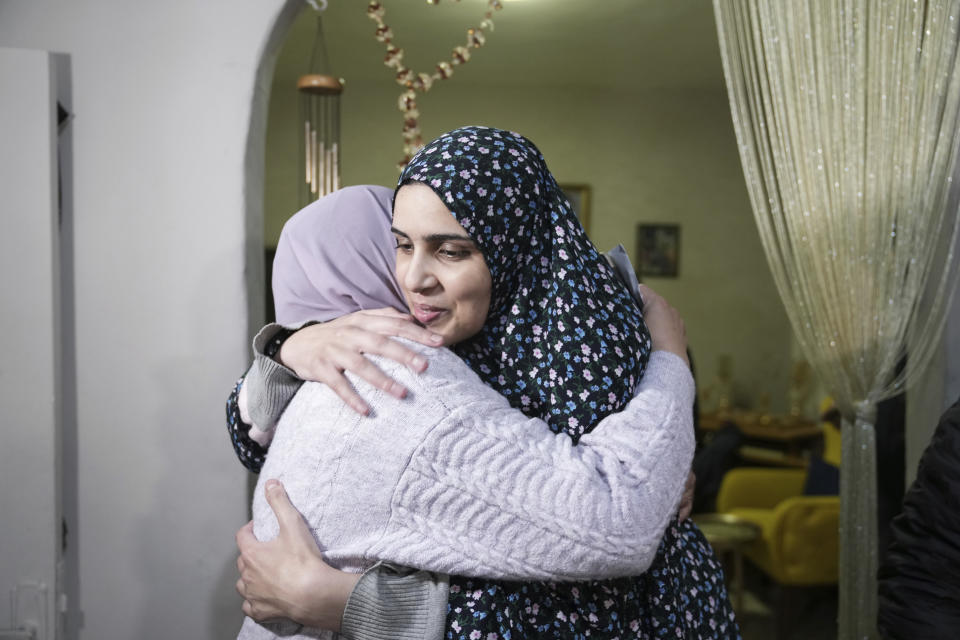 Marah Bakir, right, a former Palestinian prisoner who was released by the Israeli authorities, is welcome at her family house in the east Jerusalem neighborhood of Beit Hanina, Friday, Nov. 24, 2023. The release came on the first day of a four-day cease-fire deal between Israel and Hamas during which the Gaza militants have pledged to release 50 hostages in exchange for 150 Palestinians imprisoned by Israel. (AP Photo/Mahmoud Illean)