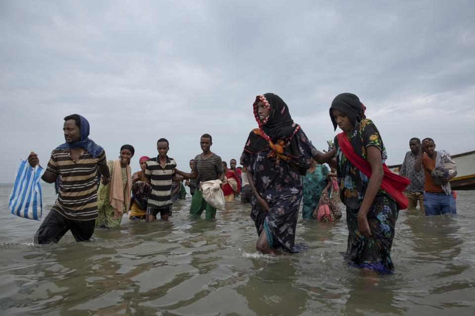 In this July 26, 2019 photo, Ethiopian migrants disembark from a boat onto the shores of Ras al-Ara, Lahj, Yemen. Funded by the European Union, Ethiopia has cracked down on migrant smugglers and intensified border controls. Arrests of known brokers have prompted migrants to turn to unreliable traffickers, taking more dangerous paths and increasing the risk of abuses. (AP Photo/Nariman El-Mofty)