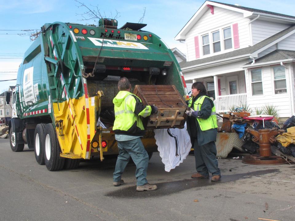 Sanitation workers collect some of the tons of ruined household items from homes in Point Pleasant Beach N.J. on Monday, Nov. 5, 2012. A new storm due Wednesday was raising fears of renewed flooding and damage at the Jersey shore, which was devastated by Superstorm Sandy. (AP Photo/Wayne Parry)