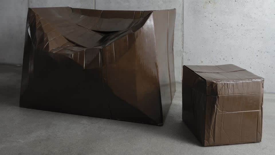 Illya Goldman Gubin strengthens misshapen cardboard boxes using resin and fiberglass. - Phillip Koll