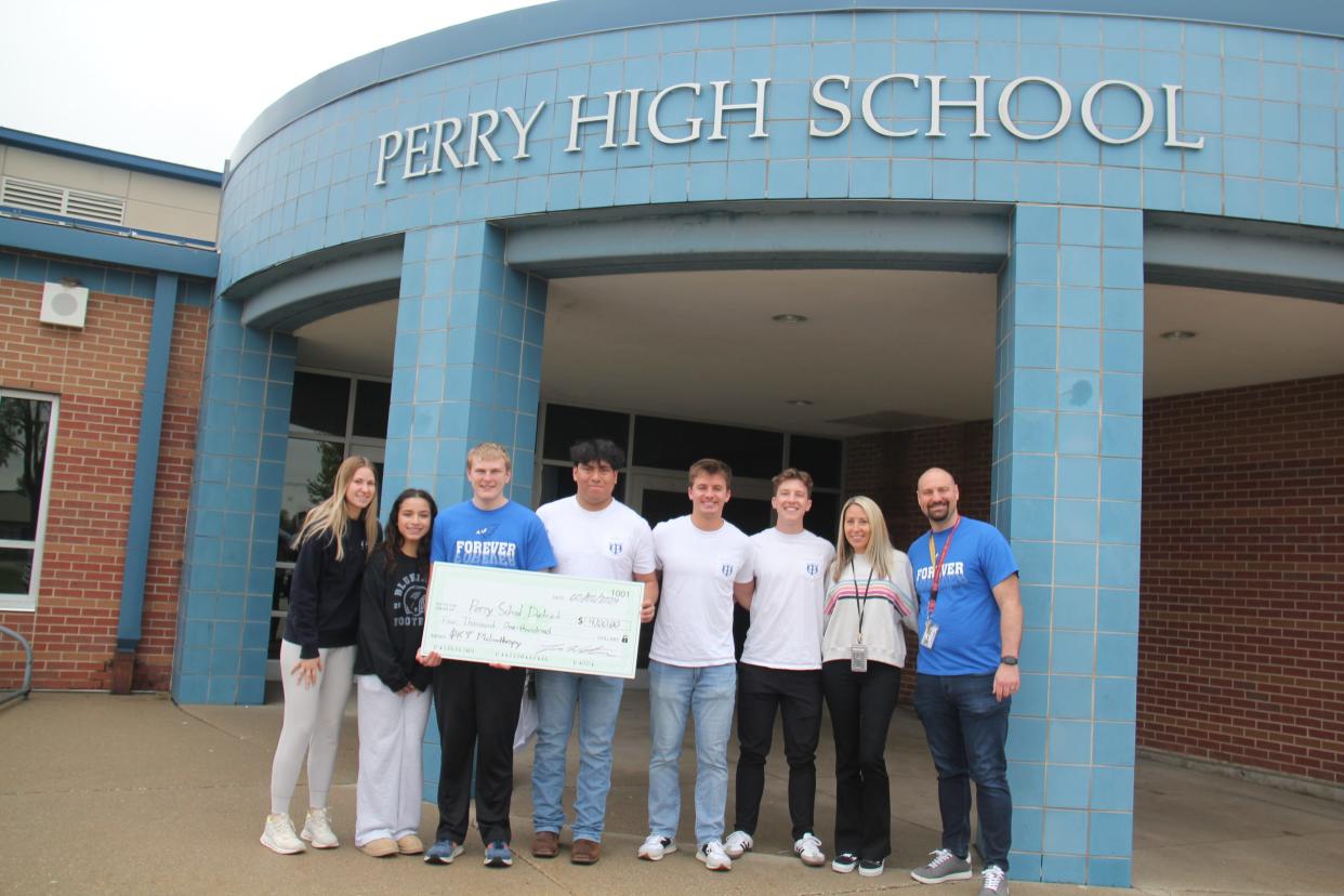Representatives from Iowa State University's Phi Kappa Psi fraternity present a check on Thursday, May 2, 2024, at Perry High School. From left, PHS students Galilea Melena, Nate Lutterman, Maci Tunink, PHS Counselor Tami Valline, ISU students Oscar Gutierrez, Luke Werthmann, Will Thomas and Perry Middle School Associate Principal Adam Jessen.