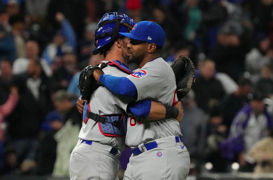 Apr 14, 2022; Denver, Colorado, USA; Chicago Cubs catcher Yan Gomes (7) and relief pitcher Mychal Givens (60) celebrate defeating the Colorado Rockies at Coors Field. Mandatory Credit: Ron Chenoy-USA TODAY Sports