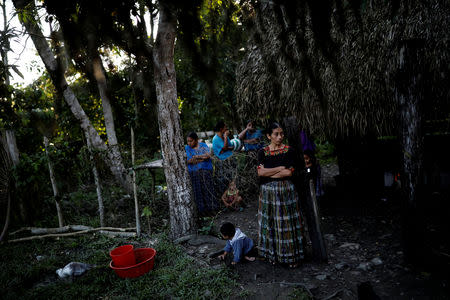 A woman waits for the arrival of a coffin with the remains of Jakelin Caal, a 7-year-old girl who died after being detained by U.S. border agents, at Jakelin's grandmother's home in San Antonio Secortez, Guatemala December 22, 2018.Picture taken December 22, 2018. REUTERS/Carlos Barria