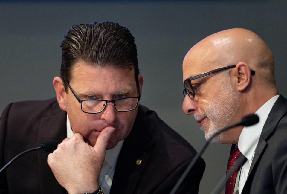 George Wysong, left, speaks with John Greco, interim city attorney, during a Miami City Commission meeting on Thursday, April 25, 2024, at Miami City Hall in Coconut Grove.