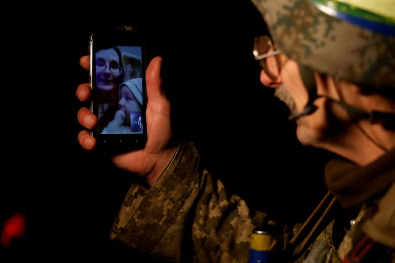 Ukrainian serviceman speaks with his family during a festive Christmas dinner in Kostiantynivka