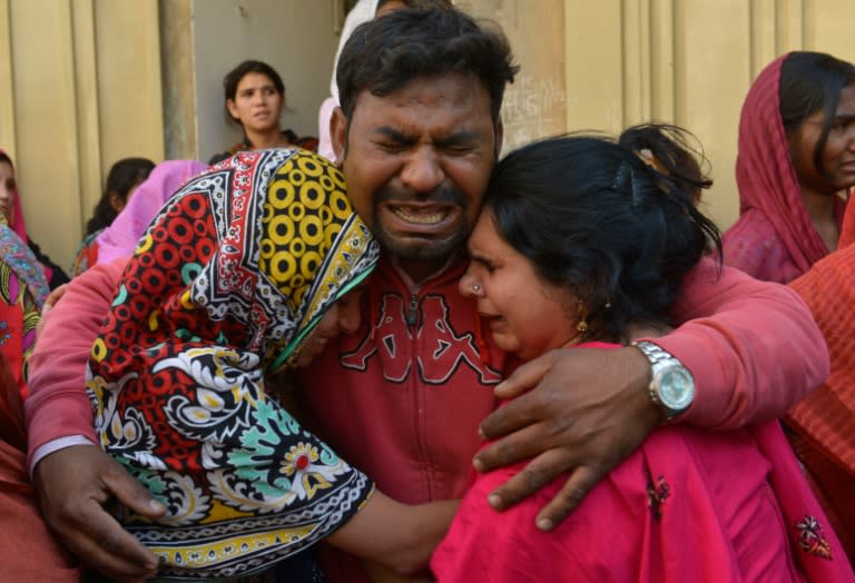 Pakistani Christians mourn the death of a blast victim, in Lahore on March 28, 2016