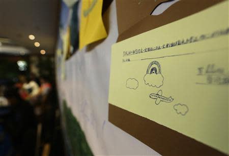 Messages dedicated to the passengers aboard Malaysia Airlines flight MH370 and their family members are displayed on a board at a room where the family members are attending a briefing given by Malaysian representatives at Lido Hotel in Beijing March 28, 2014. REUTERS/Jason Lee