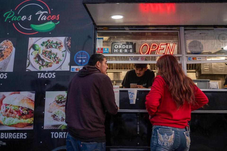 Paco’s Tacos food truck serves a pair of customers on a recent Wednesday.