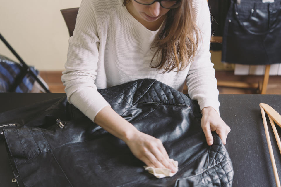 Woman cleaning leather jacket