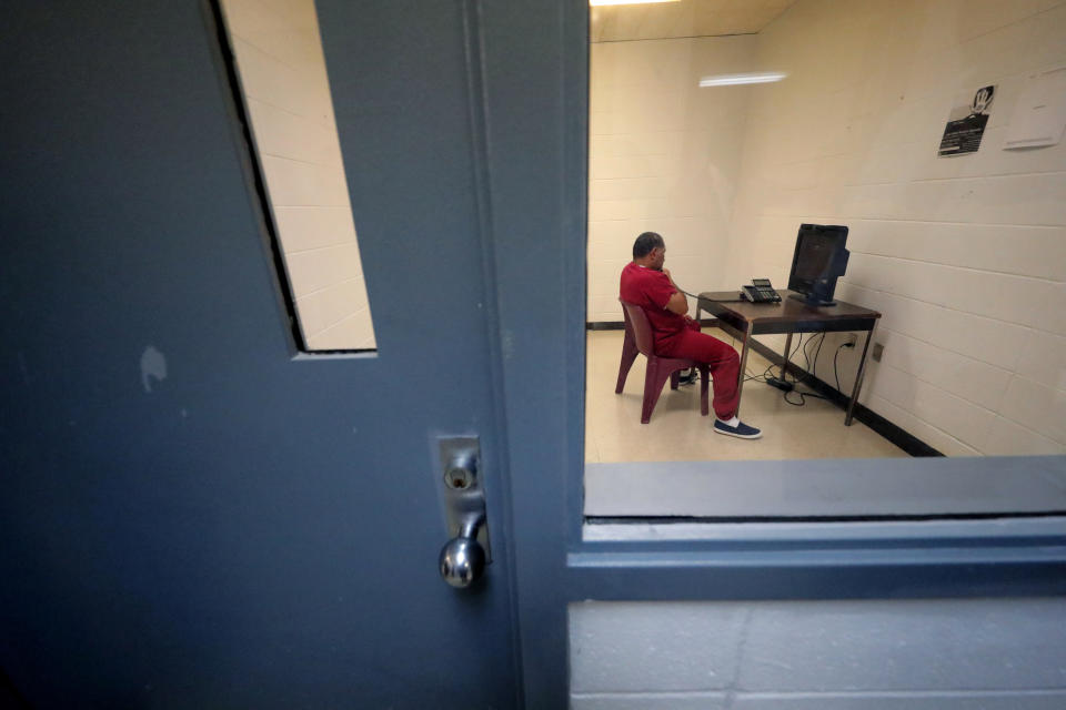 A detainee sits in a room to use a telephone inside the Winn Correctional Center in Winnfield, La., Thursday, Sept. 26, 2019. (AP Photo/Gerald Herbert)