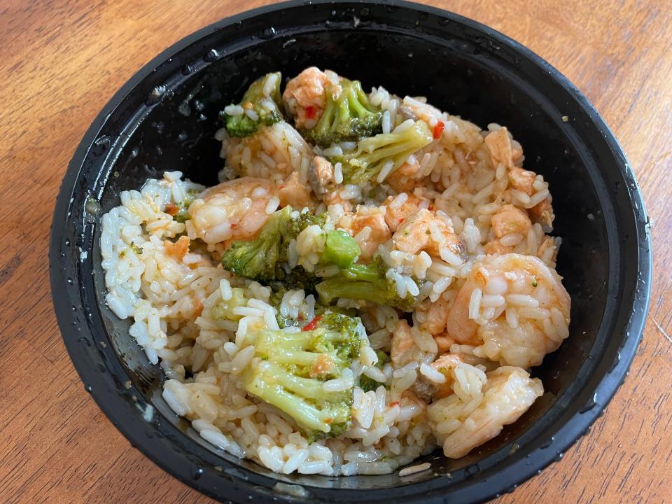 The salmon bowl is best shaken up, coating the salmon, shrimp and broccoli with sweet chili sauce and garlic butter.