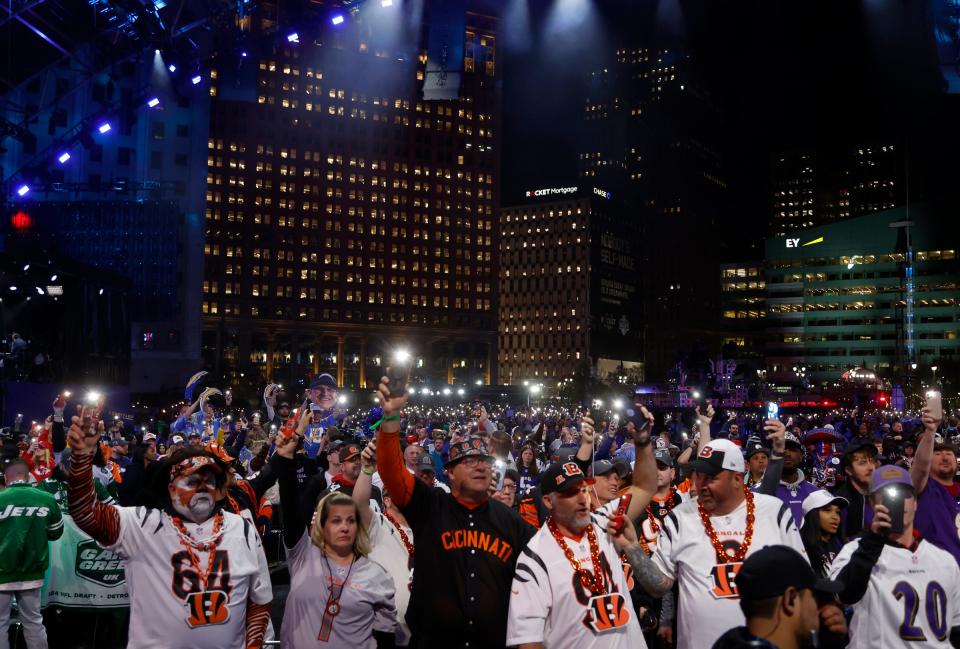 NFL fans inside the NFL Draft Theater hold up the flashlights on their phones during a break between picks in the second round in the 2024 NFL Draft in Detroit on Friday, April 26, 2024.