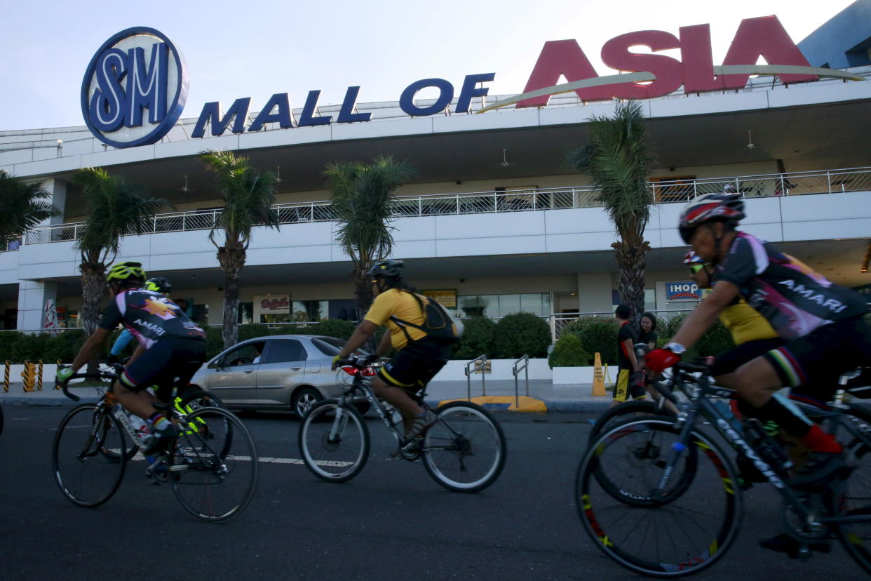 FILE PHOTO: Cyclists ride along a main street of SM Mall of Asia in Pasay City, Metro Manila on February 13, 2016. REUTERS/Romeo Ranoco/Files