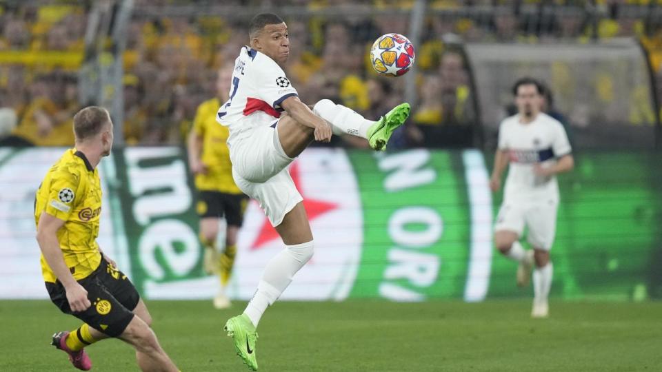 PSG's Kylian Mbappe looks to control the ball.