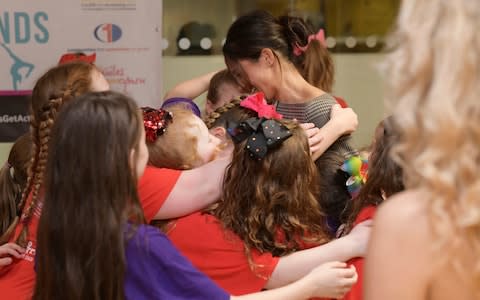 Meghan Markle hugs children from a street dance class in Cardiff - Credit: Geoff Pugh