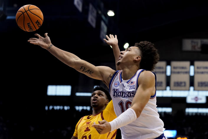 Kansas forward Jalen Wilson, front, gets past Iowa State center Osun Osunniyi to put up a shot during the first half of an NCAA college basketball game Saturday, Jan. 14, 2023, in Lawrence, Kan. (AP Photo/Charlie Riedel)
