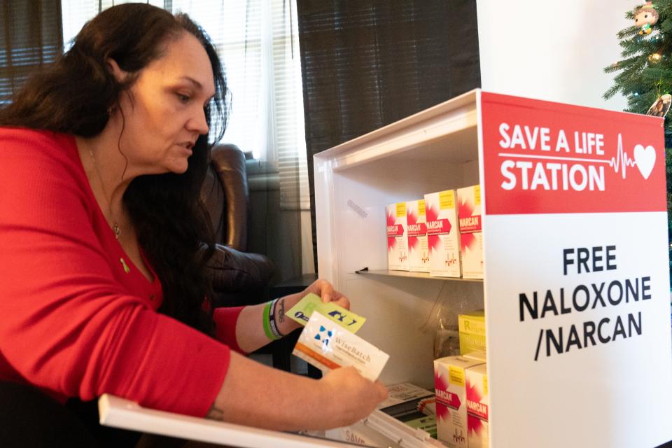 Amber Saale-Burger shows items included in a Save-a-Life Station, including drug testing kits, naloxone and information telling how to spot someone who is overdosing.