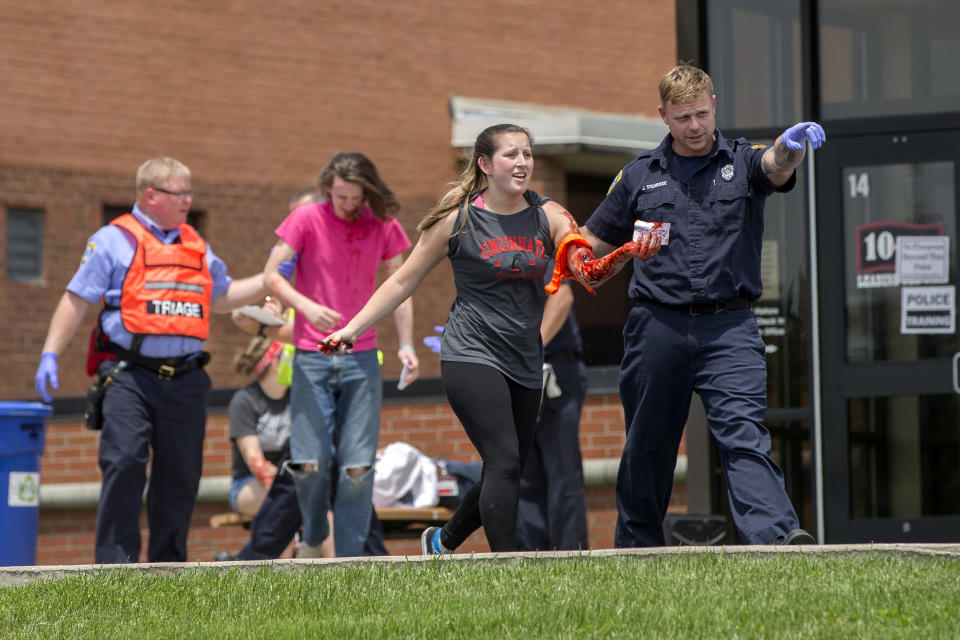 An emergency worker directs a volunteer with simulated injuries during a training exercise for an active shooter situation at Hopewell Elementary School in West Chester, Ohio, on May 25, 2016. (Photo: John Minchillo/AP)