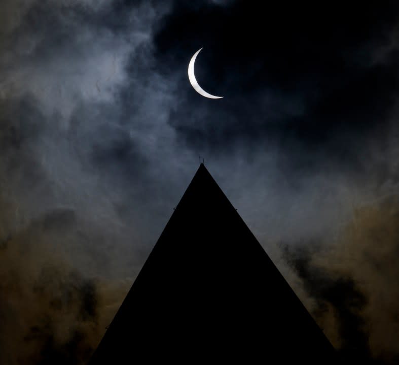 The moon is seen passing in front of the sun with the top of the Washington Monument in silhouette during a solar eclipse in Washington on Monday, April 8, 2024. (Bill Ingalls/NASA via AP)