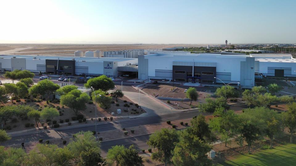     A large complex made up of several large white buildings, seen from above. 