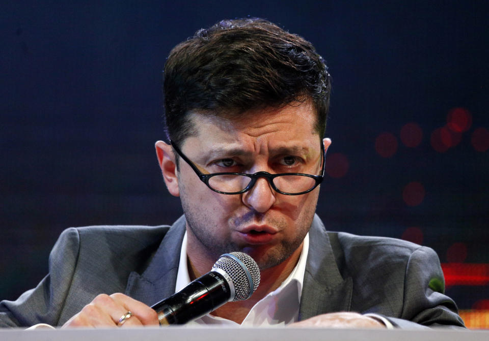 FILE - In this Friday, March 29, 2019 file photo, Volodymyr Zelenskiy, Ukrainian actor and candidate in the upcoming presidential election, hosts a comedy show at a concert hall in Brovary, Ukraine. Ukraine’s presidential runoff on Sunday, April 21, is a battle between a billionaire tycoon who rode anti-Russian protests to the nation’s top office five years ago, and a comedian who plays a president in a TV sitcom. The actor has used humor and social media to take pole position. (AP Photo/Efrem Lukatsky, file)