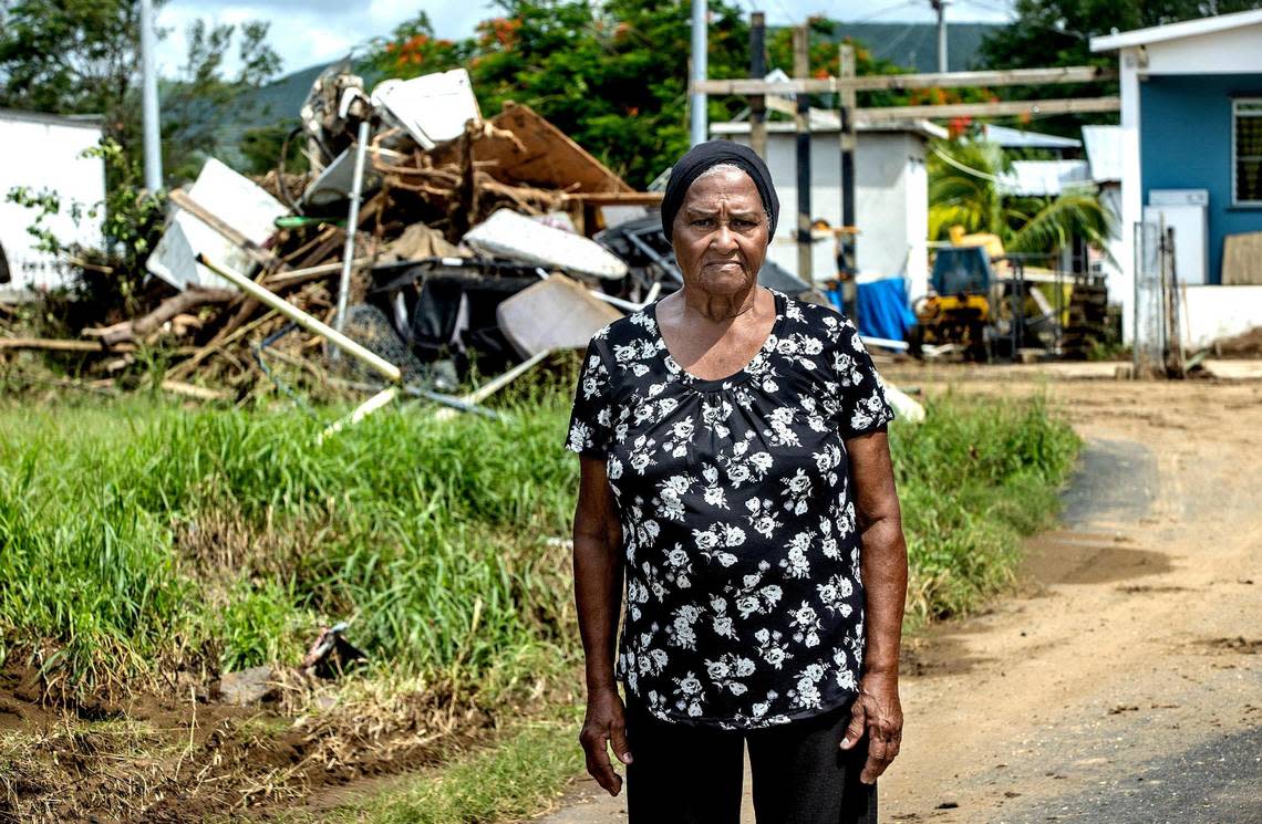 Brunilda Colón, 79, an iconic figure in her neighborhood, stands on the street by her house after Hurricane Fiona flooded Villa Esperanza in Salinas, Puerto Rico, on Friday, Sept. 23, 2022.