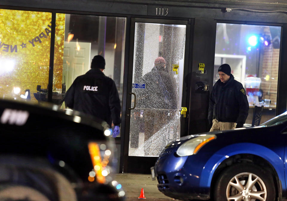 FILE - Huntington police officers investigate the scene of a shooting at a bar in Huntington, W.Va., on Jan. 1, 2020. Kymoni Davis was sentenced Monday, Dec. 19, 2022, to eight years in prison for being a felon in possession of a firearm stemming from the shooting on New Year’s Eve 2019. Prosecutors said Davis had been thrown out of the bar prior to the shooting that wounded seven people. (Lori Wolfe/The Herald-Dispatch via AP, File)