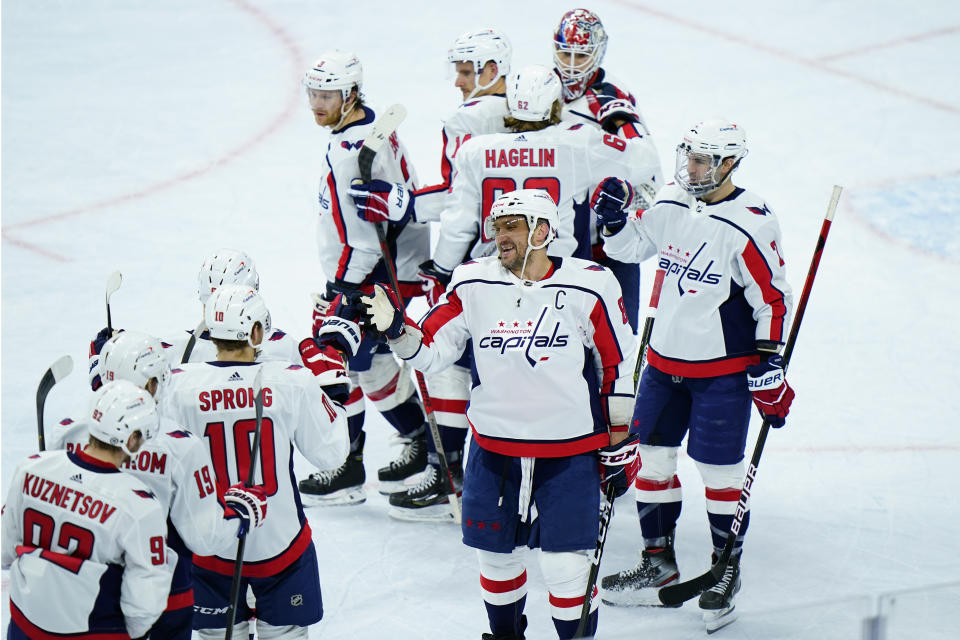 Washington Capitals' Alex Ovechkin (8) celebrates with teammates after an NHL hockey game against the Philadelphia Flyers, Sunday, March 7, 2021, in Philadelphia. (AP Photo/Matt Slocum)