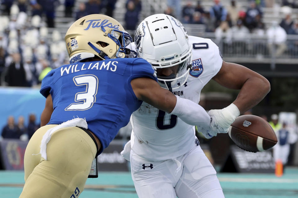 Tulsa's Cristian Williams (3) punches the ball out of the hold of Old Dominion's Ali Jennings III (0) in the first half of an NCAA college football game in the Myrtle Beach Bowl in Conway, S.C., Monday, Dec. 20, 2021. (AP Photo/Mic Smith)
