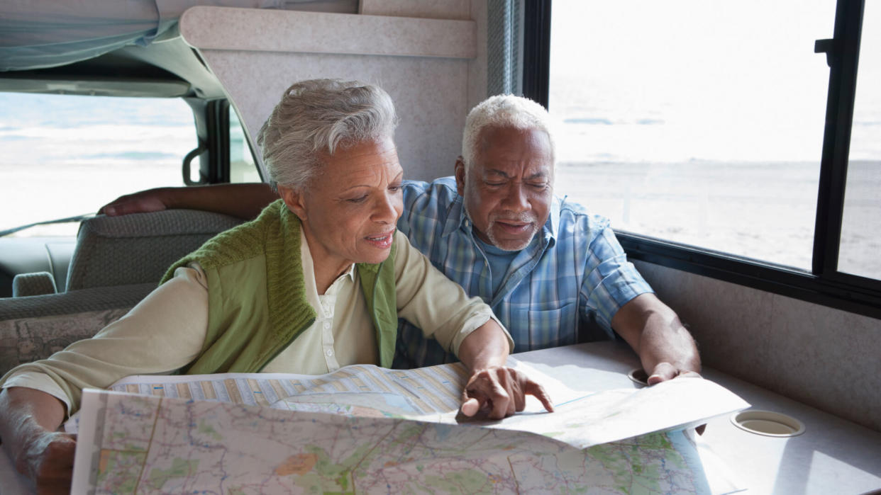 Senior couple reading map in RV