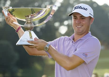 Sep 24, 2017; Atlanta, GA, USA; Justin Thomas hoists the trophy after winning the FedEx Cup following the Tour Championship golf tournament at East Lake Golf Club. Mandatory Credit: Brett Davis-USA TODAY Sports