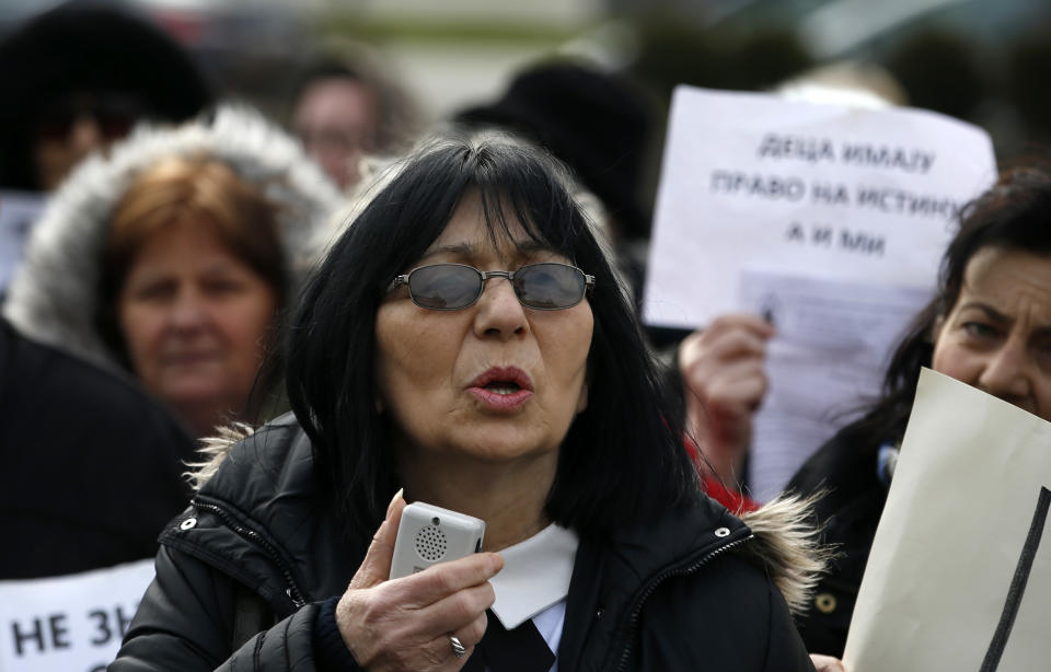 In this photo taken Monday, Feb. 24, 2020, Mirjana Novokmet speaks during a protest in front of the parliament building in Belgrade, Serbia. After years of waiting, Serbian lawmakers are set to soon pass a bill that authorities say attempts to shed light on a chilling, decades-old scandal involving hundreds of families who suspect their babies were stolen at birth. Mirjana Novokmet does not believe that this special law will help uncover what happened to her first child back in 1978. (AP Photo/Darko Vojinovic)