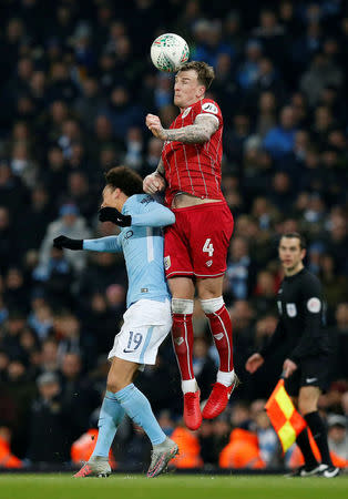 Soccer Football - Carabao Cup Semi Final First Leg - Manchester City vs Bristol City - Etihad Stadium, Manchester, Britain - January 9, 2018 Bristol City's Aden Flintin action with Manchester City's Leroy Sane REUTERS/Andrew Yates