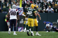 Green Bay Packers quarterback Aaron Rodgers (12) celebrates with teammate offensive tackle David Bakhtiari after throwing a touchdown pass during the second half of an NFL football game against the New England Patriots, Sunday, Oct. 2, 2022, in Green Bay, Wis. (AP Photo/Morry Gash)