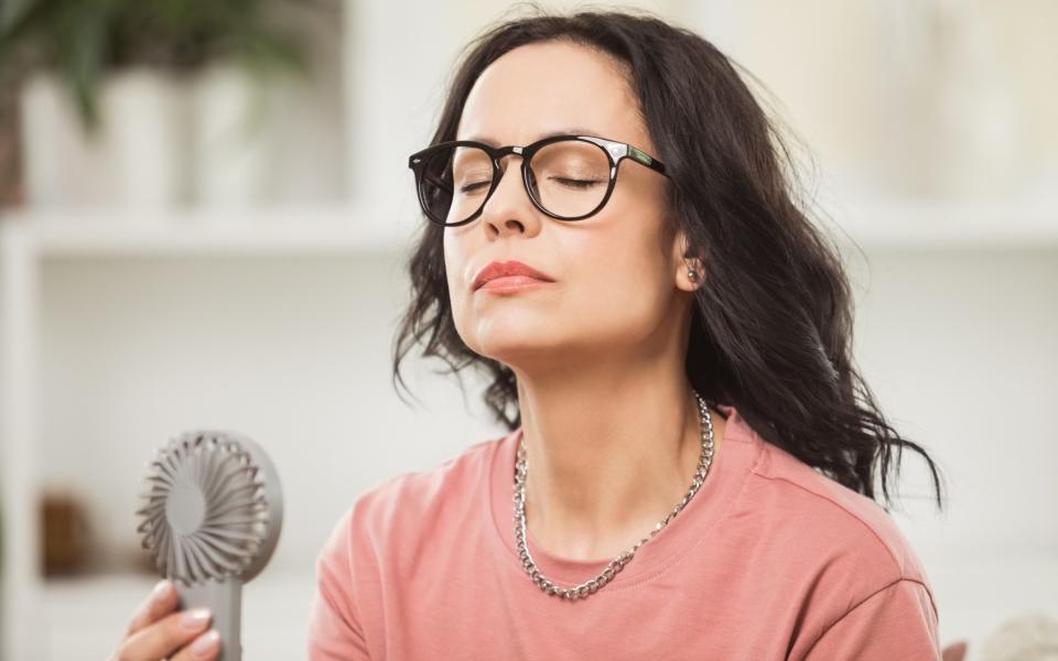 Woman using fan