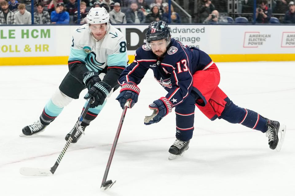 Jan 13, 2024; Columbus, Ohio, USA; Columbus Blue Jackets left wing Johnny Gaudreau (13) controls the puck in front of Seattle Kraken defenseman Brian Dumoulin (8) during the first period of the NHL hockey game at Nationwide Arena.