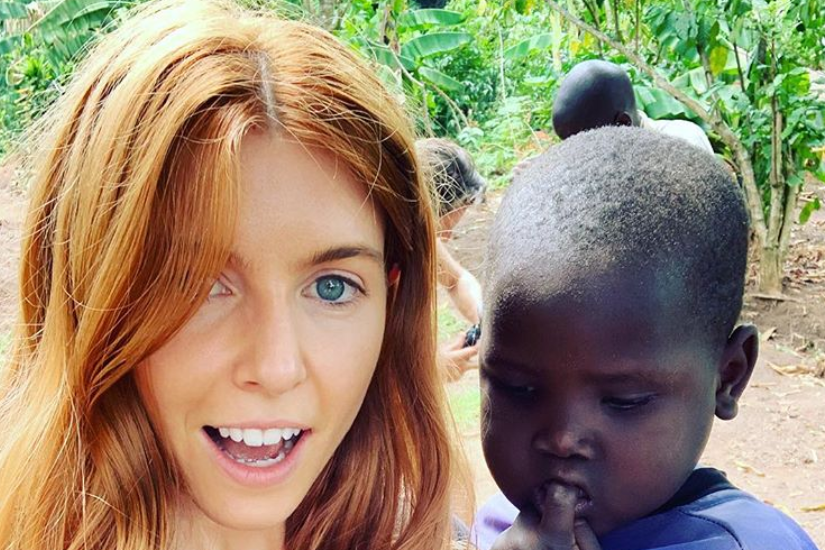 Stacey Dooley shared pictures of her trip to Uganda, with one snap showing her posing with a young child. (Stacey Dooley/Instagram)